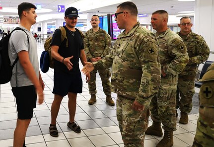 Lt. Col. Nick Krzesinski, Commander of the 634th Brigade Support Battalion, shakes hands with Staff Sgt. Jackson Bland of Springfield, Ill., after Bland returned from deployment.