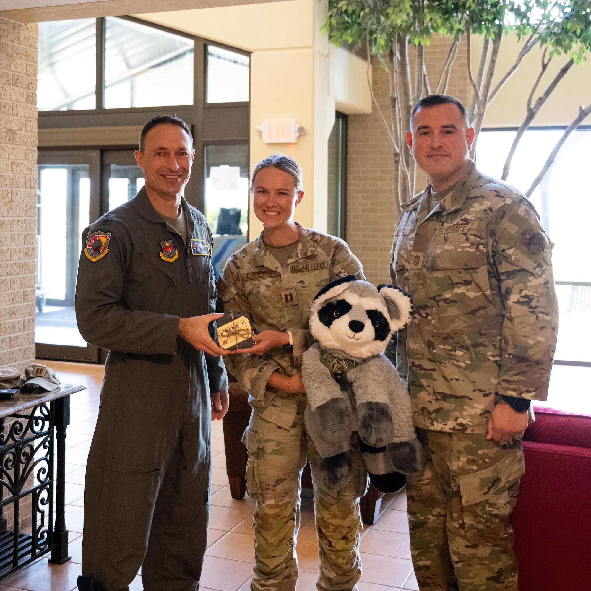U.S. Air Force Col. Tyler Ellison, 47th Flying Training Wing commander, and Chief Master Sgt. Erik Garza, 47th FTW command chief, present a second quarter award at Laughlin Air Force Base, August 1, 2025. The quarterly awards ceremony honored Airmen and civilians who demonstrated exceptional performance, leadership, and mission impact across the wing. (U.S. Air Force photo by Airman 1st Class Harrison Sullivan)