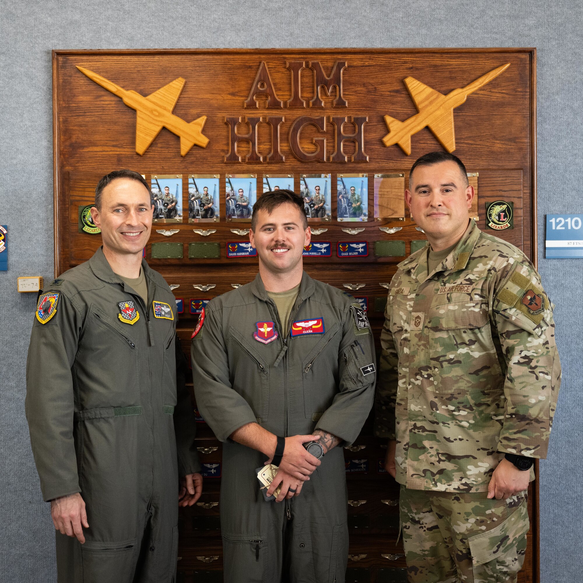 U.S. Air Force Col. Tyler Ellison, 47th Flying Training Wing commander, and Chief Master Sgt. Erik Garza, 47th FTW command chief, present a second quarter award at Laughlin Air Force Base, August 1, 2025. The quarterly awards ceremony honored Airmen and civilians who demonstrated exceptional performance, leadership, and mission impact across the wing. (U.S. Air Force photo by Airman 1st Class Harrison Sullivan)