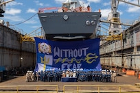 The crew of the Arleigh Burke-class guided-missile destroyer USS Laboon (DDG 58) accepts the Battenberg Cup and Arleigh Burke Trophy from Adm. Daryl Caudle, commander, U.S. Fleet Forces Command, during a ceremony held at BAE Systems Ship Repair Norfolk, Aug. 4, 2025. The Battenberg Cup has been awarded annually since 1977 to the ship or submarine selected by the fleet commander as the best all-around in the Atlantic Fleet, based on accumulation of crew achievements. (U.S. Navy photo by Mass Communication Specialist 1st Class Nathan T. Beard)