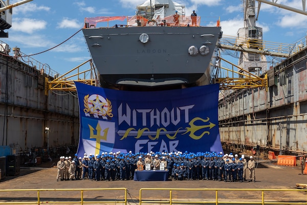 The crew of the Arleigh Burke-class guided-missile destroyer USS Laboon (DDG 58) accepts the Battenberg Cup and Arleigh Burke Trophy from Adm. Daryl Caudle, commander, U.S. Fleet Forces Command, during a ceremony held at BAE Systems Ship Repair Norfolk, Aug. 4, 2025. The Battenberg Cup has been awarded annually since 1977 to the ship or submarine selected by the fleet commander as the best all-around in the Atlantic Fleet, based on accumulation of crew achievements. (U.S. Navy photo by Mass Communication Specialist 1st Class Nathan T. Beard)