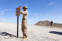 U.S. Marine Corps Cpl. Manuel Cruz, left, and  Lance Cpl. Ayden Aguirre, right, both with Combat Logistics Battalion 15, Combat Logistics Regiment 17, 1st Marine Logistics Group, assigned to Joint Task Force-Southern Border, execute National Defense area sign emplacement near Yuma, Ariz., July 31, 2025. JTF-SB executes full-scale, agile, and all-domain operations in support of U.S. Customs and Border Protection to protect the territorial integrity of the United States and achieve 100% operational control of the southern border. (U.S. Marine Corps photo by Sgt. Mary Torres)
