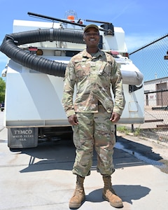 Image of Airman 1st Class David Odida in front of Bobcat.