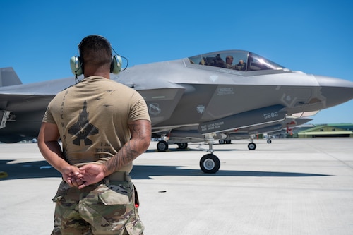 A U.S. Air Force Airman, assigned to the 421st Fighter Generation Squadron, prepares to send off an F-35 Lightning II during exercise Resolute Force Pacific 2025 at Matsushima Air Base, Japan, July 25, 2025