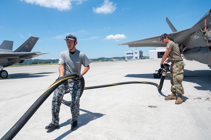 A U.S. Air Force Airman, assigned to the 421st Fighter Generation Squadron, and a Japan Air Self-Defense Force airman, assigned to the 4th Air Wing, refuel 421st Fighter Squadron F-35 Lightning IIs during exercise Resolute Force Pacific (REFORPAC) 2025 at Matsushima Air Base, Japan, July 25, 2025