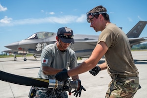 A Japan Air Self-Defense Force airman, assigned to the 4th Air Wing, and a U.S. Air Force Airman, assigned to the 421st Fighter Generation Squadron, refuel 421st Fighter Squadron F-35 Lightning IIs during exercise Resolute Force Pacific 2025 at Matsushima Air Base, Japan, July 25, 2025