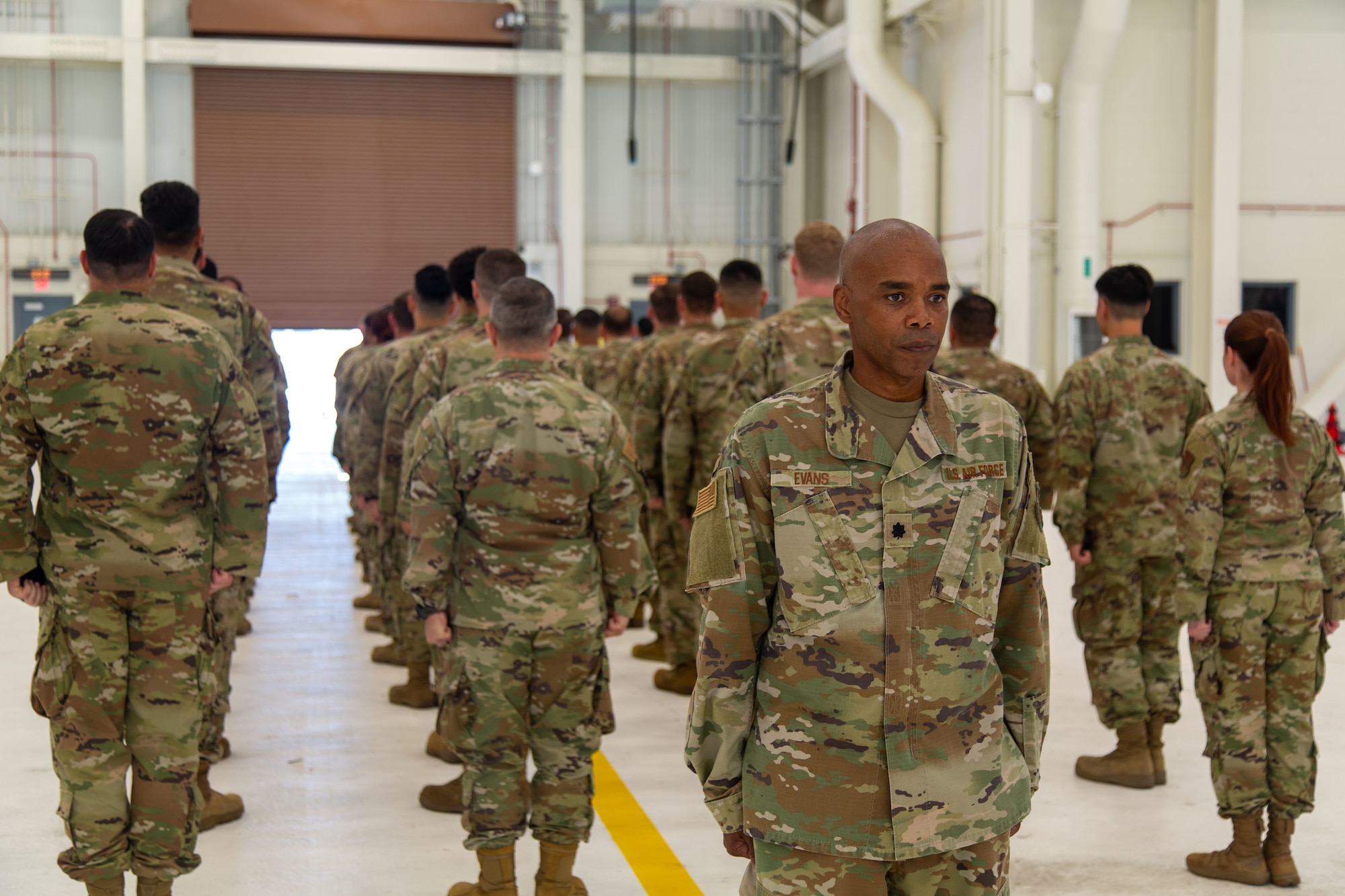 Former 45th Aerial Port Squadron Commander, Lt. Col. Conrad Evans, faces opposite from the former members of the 45 APS during the inactivation ceremony at Travis AFB, Calif. on Aug. 2, 2025. The ceremony honored the legacy of the APS and recognized its distinguished history and achievements.