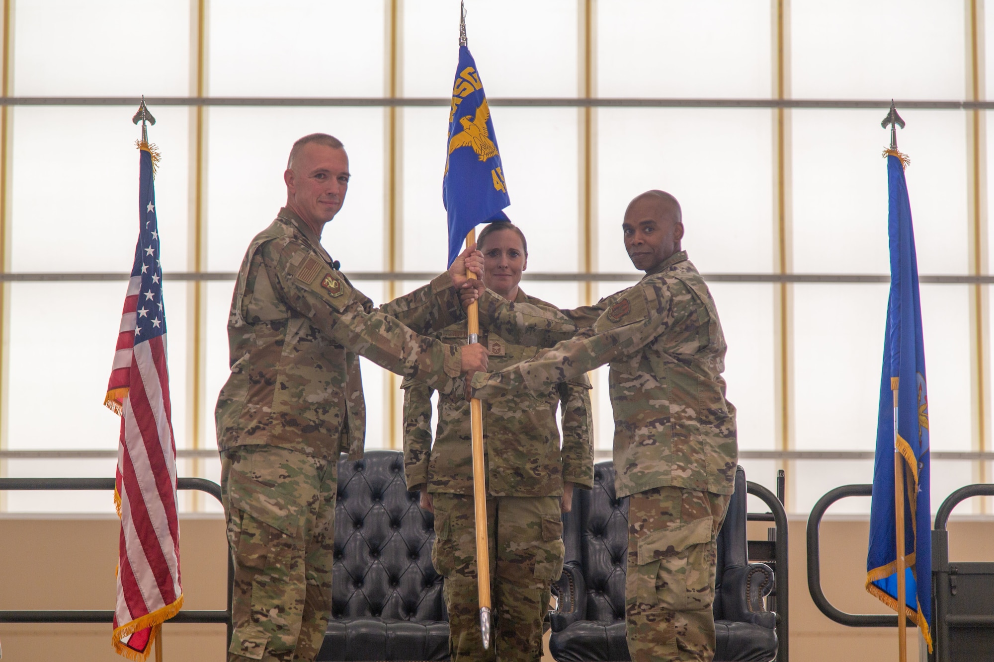 349th Mission Support Group Commander and presiding official, Lt Col Dennis Hale receives the 45th Aerial Port Squadron guidon from 45 APS Commander Lt. Col. Conrad Evans during the squadron's inactivation ceremony at Travis AFB, Calif. on Aug. 2, 2025.