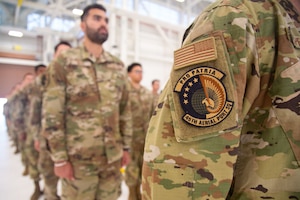 Members of the 45th Aerial Port Squadron stand in formation during their inactivation ceremony at Travis AFB, Calif. on Aug. 2, 2025.