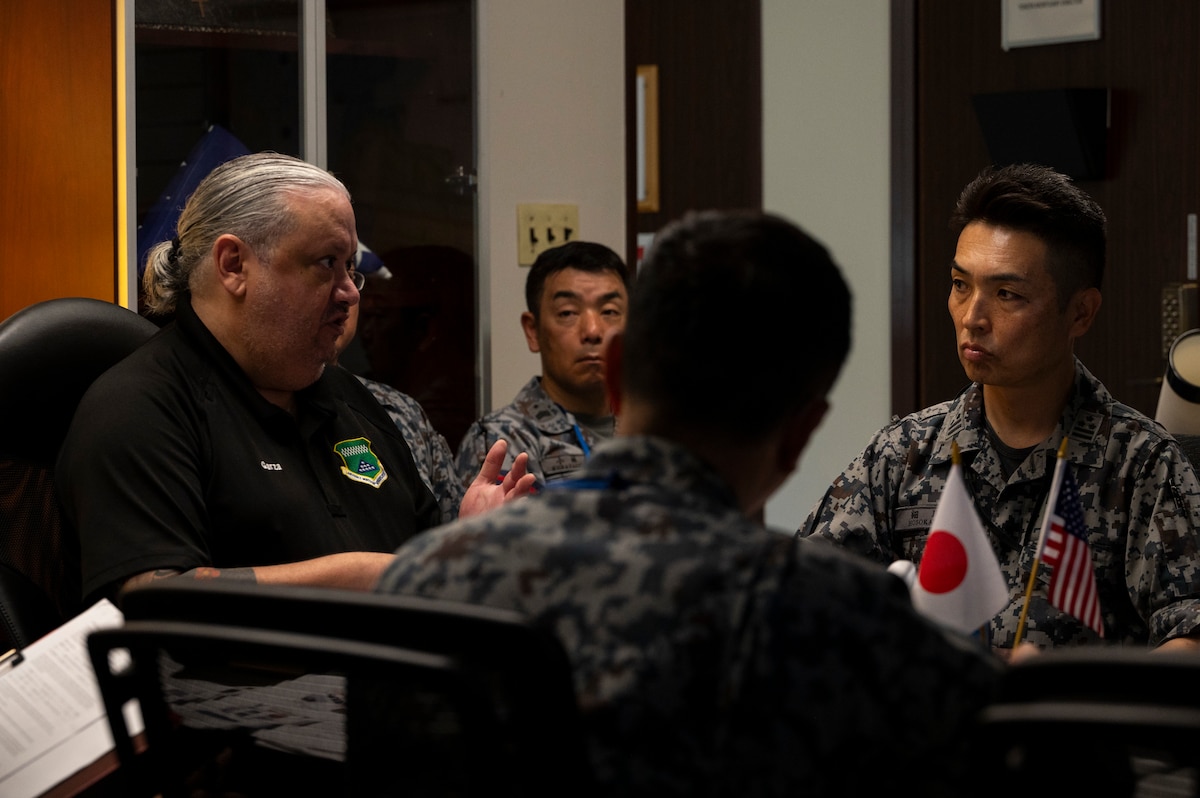 A civilian mortuary director briefs Japan Air Self-Defense Force members.