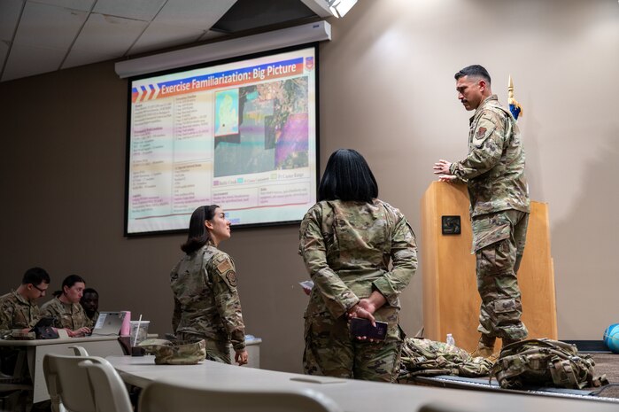 U.S. Air Force Chief Master Sgt. Erick Lizarraga, right, 22nd Air Task Force (ATF) command chief, speaks to in-processing personnel in preparation for Exercise Northern Strike 25-2 (NS 25-2) at Fort Custer, Michigan, Aug. 3, 2025.