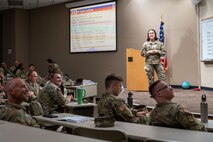 U.S. Air Force 2nd Lt. Lela Buda, 22nd Combat Air Base Squadron (CABS) Force Support Squadron officer, briefs Soldiers in preparation for Exercise Northern Strike 25-2 (NS 25-2) at Fort Custer, Michigan, Aug. 3, 2025.