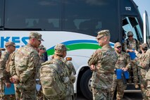 U.S. Air Force Col. William J. Watkins, center right 22nd Air Task Force (ATF) commander and Chief Master Sgt. Erick Lizarraga, left, 22nd ATF command chief, welcome arriving participants at Fort Custer, Michigan, Aug. 3, 2025.