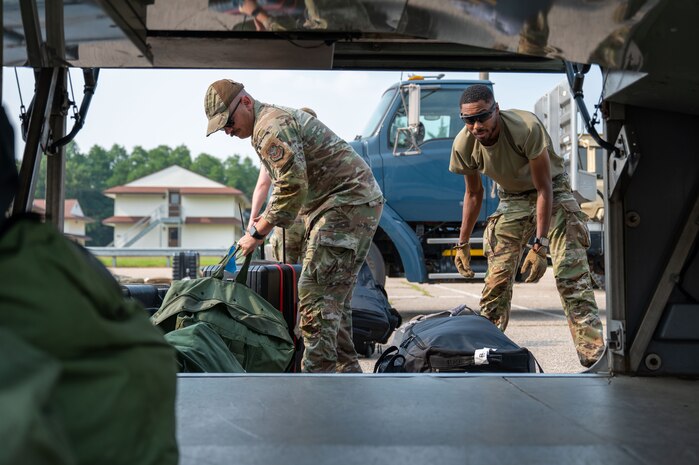 U.S. Airmen from various installations assigned to the 22nd Air Task Force (ATF) unload luggage in preparation for Exercise Northern Strike 25-2 (NS 25-2) at Fort Custer, Michigan, Aug. 3, 2025.