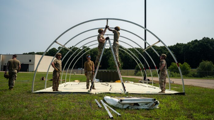 U.S. Airmen from various installations assigned to the 22nd Air Task Force (ATF) secure tent frame sections as part of the advanced echelon (ADVON) team in preparation for Exercise Northern Strike 25-2 (NS 25-2) at Battle Creek Air National Guard Base, Michigan, Aug. 2, 2025.