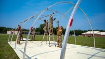 U.S. Airmen from various installations assigned to the 22nd Air Task Force (ATF) secure tent frame sections as part of the advanced echelon (ADVON) team in preparation for Exercise Northern Strike 25-2 (NS 25-2) at Battle Creek Air National Guard Base, Michigan, Aug. 2, 2025.