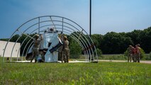 U.S. Airmen from various installations assigned to the 22nd Air Task Force (ATF) position a tent’s outer shell as part of the advanced echelon (ADVON) team while Wing Inspection Team members observe in preparation for Exercise Northern Strike 25-2 (NS 25-2) at Battle Creek Air National Guard Base, Michigan, Aug. 2, 2025.