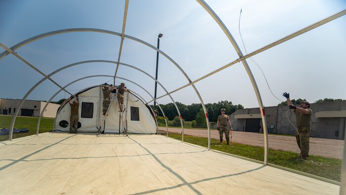 U.S. Airmen from various installations assigned to the 22nd Air Task Force (ATF) secure a tent’s outer shell as part of the advanced echelon (ADVON) team in preparation for Exercise Northern Strike 25-2 (NS 25-2) at Battle Creek Air National Guard Base, Michigan, Aug. 2, 2025.