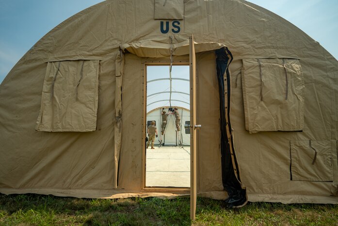 U.S. Airmen from various installations assigned to the 22nd Air Task Force (ATF) secure a tent’s outer shell as part of the advanced echelon (ADVON) team in preparation for Exercise Northern Strike 25-2 (NS 25-2) at Battle Creek Air National Guard Base, Michigan, Aug. 2, 2025.