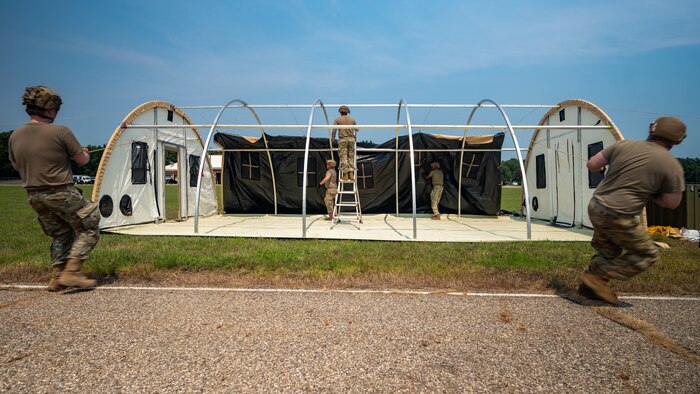 U.S. Airmen from various installations assigned to the 22nd Air Task Force (ATF) pull a tent’s outer shell over its frame as part of the advanced echelon (ADVON) team in preparation for Exercise Northern Strike 25-2 (NS 25-2) at Battle Creek Air National Guard Base, Michigan, Aug. 2, 2025.