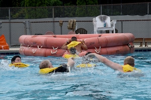 Pilots and boom operators assigned to the 106th and 99th Air Refueling Squadrons swim for their rescue raft during water survival training in Trussville, Ala., August 2, 2025.