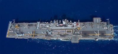 CORAL SEA (Aug. 2, 2025) — Sailors assigned to the forward-deployed amphibious assault ship USS America (LHA 6) and U.S. Marines with the 31st Marine Expeditionary Unit stand in formation for a photo commemorating 250 years of naval service, while...