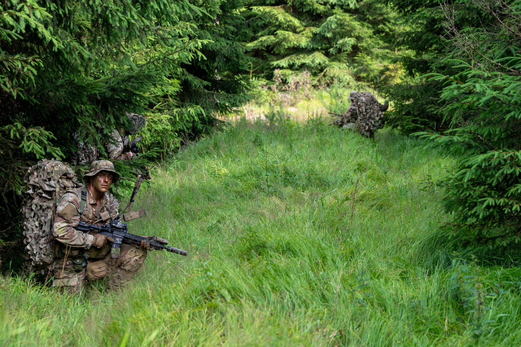 A U.S. Air Force Airman assigned to the 2nd Air Support Operations Squadron provides overwatch as his unit scouts ahead during a reconnaissance mission at a training area near Vilseck Army Base, Germany, July 15, 2025.