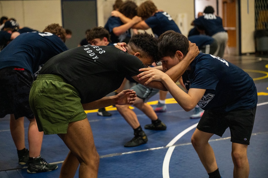 U.S. Marine Corps Sergeant Cheyenne Jackson, a recruiter with Recruiting Station Lansing, 4th Marine Corps District, performs wrestling techniques during a Sports Leaders Academy wrestling event at Fraser Highschool, Fraser, Michigan, June 14, 2025. The wrestling academy consisted of technique sessions, active practice, and leadership talks provided by the Marines. Jackson is a native of Detroit, Michigan. (U.S. Marine Corps photo by Sgt. Israel Sheber)
