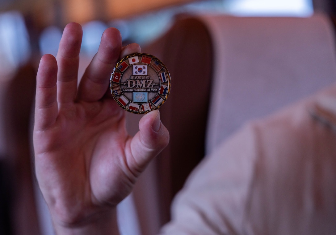 A U.S. Marine with 2nd Battalion, 23rd Marines, forward deployed with 4th Marine Regiment, 3rd Marine Division as part of the Unit Deployment Program, holds a demilitarized zone coin during a DMZ tour as part of the Korean Marine Exercise Program 25.2, in Paju, South Korea, Aug. 1, 2025. KMEP is conducted regularly between the ROK and U.S. Marine Corps to increase their combined capabilities through realistic training geared towards deterrence and maintaining peace in the Indo-Pacific. (U.S. Marine Corps photo by Cpl. Kanoa Thomas)