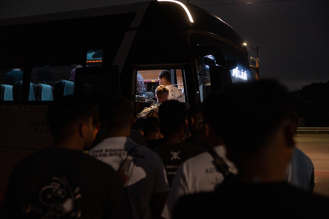 U.S. Marines with 2nd Battalion, 23rd Marines, forward deployed with 4th Marine Regiment, 3rd Marine Division as part of the Unit Deployment Program, prepare to board a bus to the demilitarized zone during the Korean Marine Exercise Program 25.2, on Camp Mujuk, South Korea, Aug. 1, 2025. KMEP is conducted regularly between the ROK and U.S. Marine Corps to increase their combined capabilities through realistic training geared towards deterrence and maintaining peace in the Indo-Pacific.  (U.S. Marine Corps photo by Cpl. Kanoa Thomas)