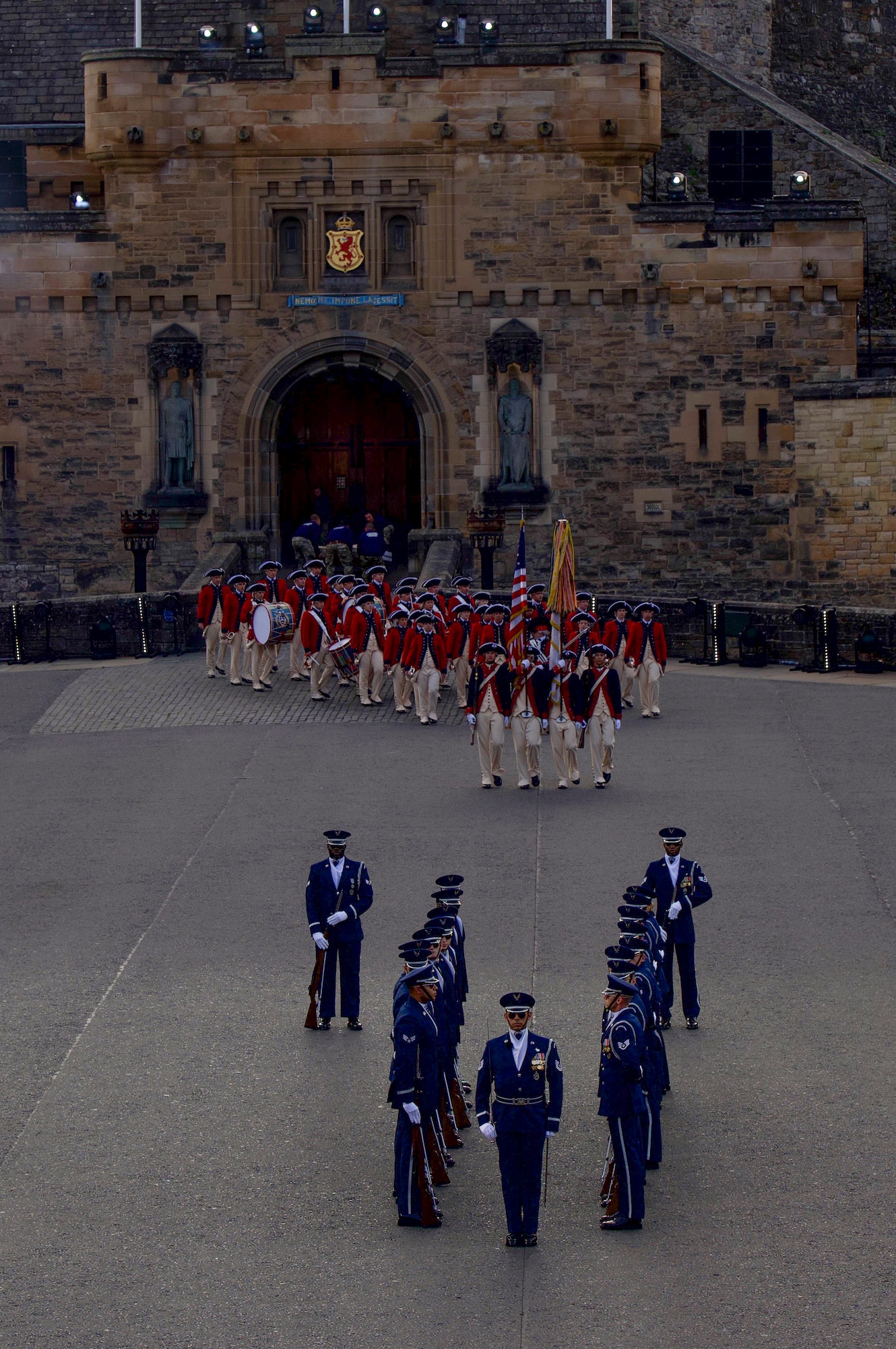 The U.S. Air Force Honor Guard Drill Team finishes their repertoire as the U.S. Army Old Guard Fife and Drum Corps enters the stage during the rehearsal of the 75th Royal Edinburgh Military Tattoo in Edinburgh, Scotland, July 31, 2025.