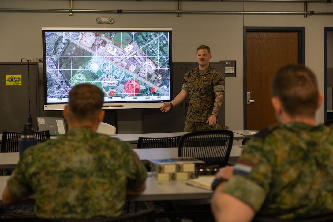 U.S. Marine Corps Capt. Michael J. Prusz, a crew chief with 2nd Air Naval Gunfire Liaison Company, II Marine Expeditionary Force Information Group, conducts an urban close air support brief during exercise Burmese Chase 25 at Marine Corps Base Camp Lejeune, North Carolina, Aug. 4, 2025. Burmese Chase is an annual U.S. led, multi-lateral training exercise comprised of integrating ground and air fires, infantry tactics and naval gunfire alongside NATO allies to enhance combat readiness and interoperability. (U.S. Marine Corps photo by Cpl. Aydan Millette)U.S. Marine Corps Capt. Michael J. Prusz, a crew chief with 2nd Air Naval Gunfire Liaison Company, II Marine Expeditionary Force Information Group, conducts an urban close air support brief during exercise Burmese Chase 25 at Marine Corps Base Camp Lejeune, North Carolina, Aug. 4, 2025. Burmese Chase is an annual U.S. led, multi-lateral training exercise comprised of integrating ground and air fires, infantry tactics and naval gunfire alongside NATO allies to enhance combat readiness and interoperability. (U.S. Marine Corps photo by Cpl. Aydan Millette)