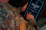 Service member clicks on tablet. Screen reads: "Your visit with your clinician is about to begin."