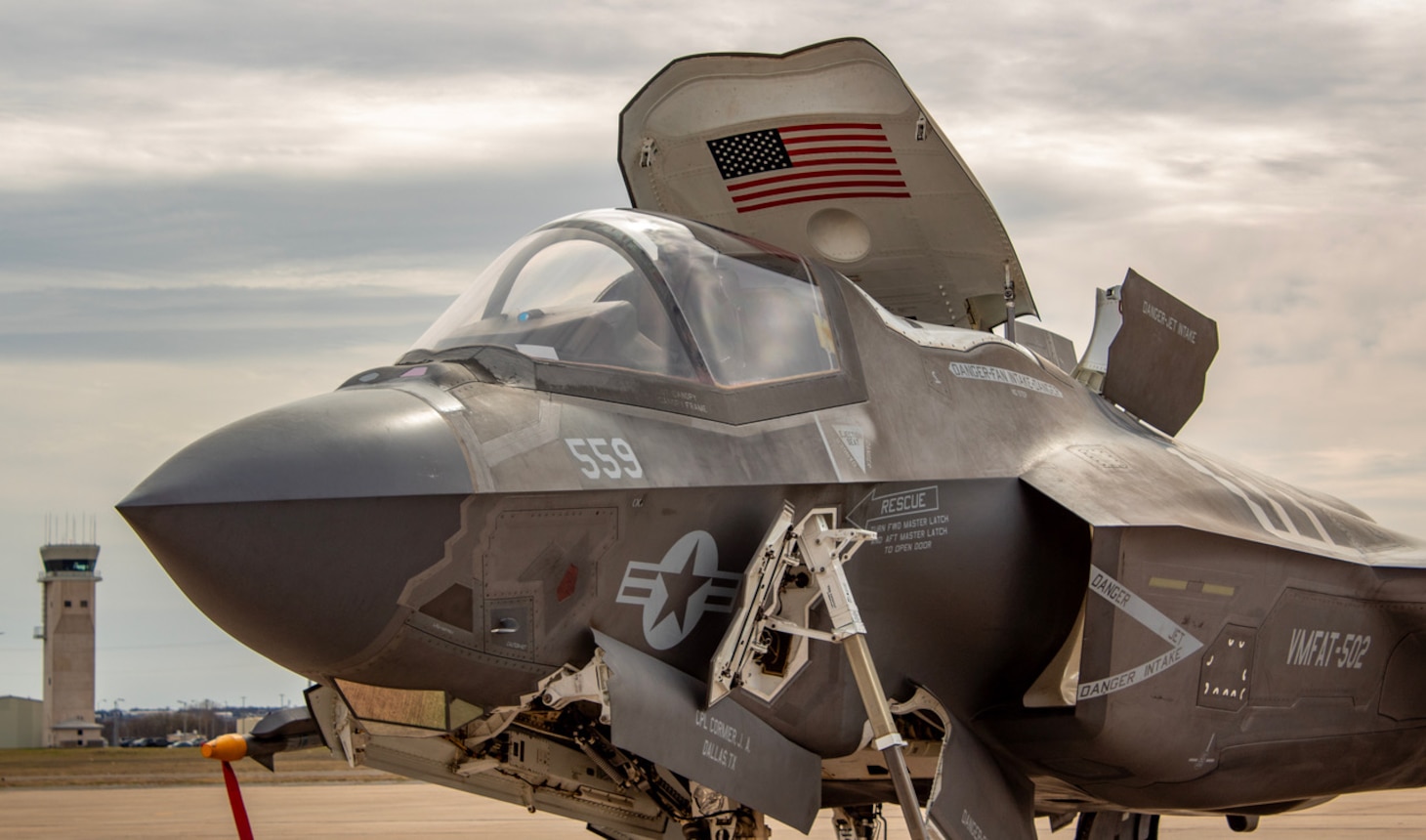 An F-35B Lightning II from Marine Fighter Attack Training Squadron 502, the 'Flying Nightmares,' sits with its canopy open during a training detachment at Naval Air Station Joint Reserve Base Fort Worth, Texas, March 2025. The open hatch facilitates pre-flight checks and pilot preparation as the squadron refines air-to-air and air-to-surface combat skills for operational readiness.
