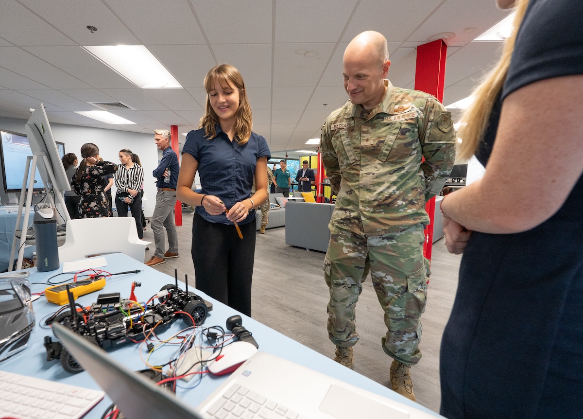 An Air Force commander, reviews a nano board during a STEM showcase.