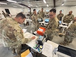 New York Army National Guard 1st Lt. Michael Catalano, the executive officer of the 37th Finance Company, and the Disbursing Agent, disburses training funds to his cashiers at the beginning of the business day allowing them to perform transactions for the day during Exercise Diamond Saber in July at Joint Base McGuire-Dix-Lakehurst. The two-week long finance training exercise enables finance Soldiers to spend a week operating as they would when deployed.