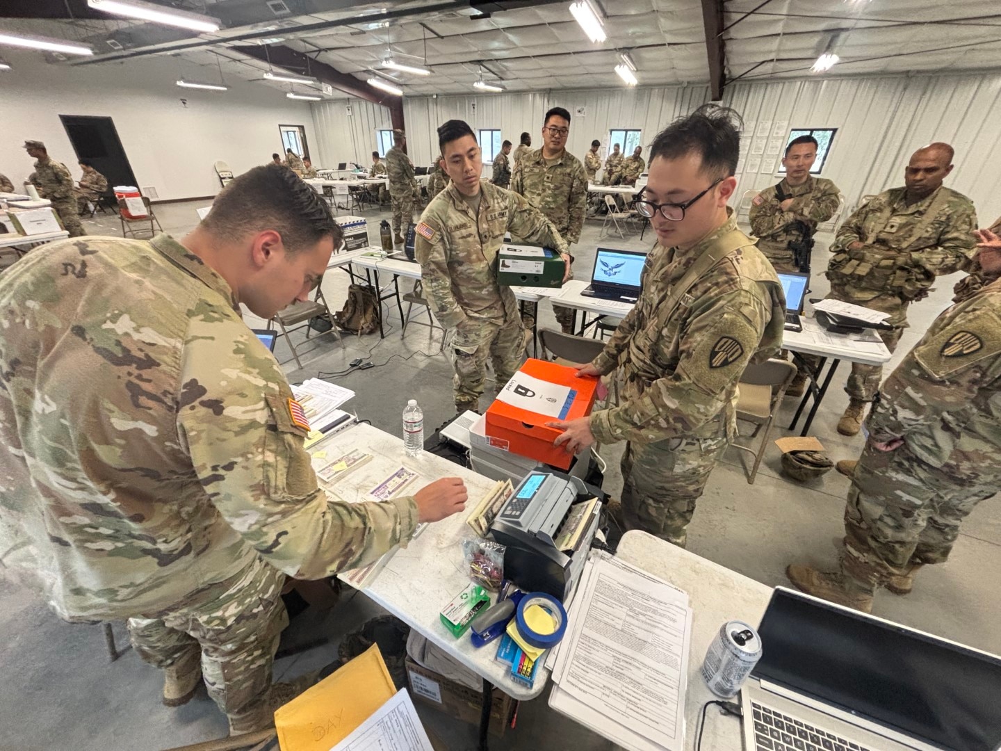 New York Army National Guard 1st Lt. Michael Catalano, the executive officer of the 37th Finance Company, and the Disbursing Agent, disburses training funds to his cashiers at the beginning of the business day allowing them to perform transactions for the day during Exercise Diamond Saber in July at Joint Base McGuire-Dix-Lakehurst.