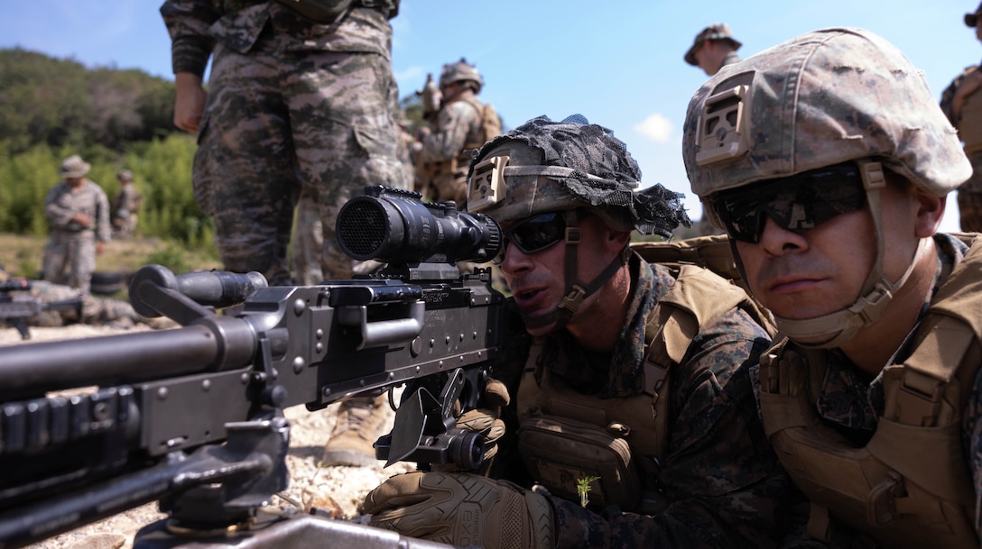 U.S. Marine Corps Cpl. Joshua Bailey, left, a squad leader, and Sgt. Oscar Ochoa, a machine gunner, both with 2nd Battalion, 23rd Marines, forward deployed with 4th Marine Regiment, 3rd Marine Division as part of the Unit Deployment Program, conduct M240B machine gun drills during the Korean Marine Exercise Program 25.2 in Suseong-ri, South Korea, July 30, 2025. KMEP is conducted regularly between the ROK and U.S. Marine Corps to increase their combined capabilities through realistic training geared towards deterrence and maintaining peace in the Indo-Pacific. Bailey is a native of Alabama, and Ochoa is a native of California. (U.S. Marine Corps photo by Cpl. Kanoa Thomas)