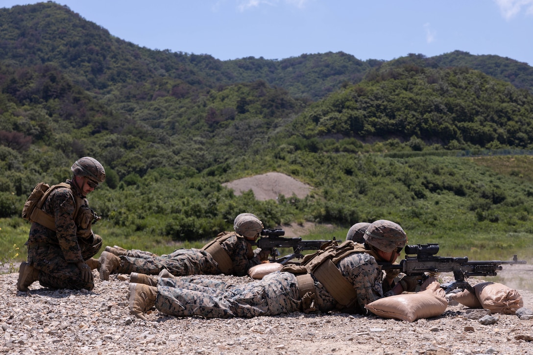 U.S. Marines with 2nd Battalion, 23rd Marines, forward deployed with 4th Marine Regiment, 3rd Marine Division as part of the Unit Deployment Program, fire M240B machine guns during the Korean Marine Exercise Program 25.2 in Suseong-ri, South Korea, July 30, 2025. KMEP is conducted regularly between the ROK and U.S. Marine Corps to increase their combined capabilities through realistic training geared towards deterrence and maintaining peace in the Indo-Pacific. (U.S. Marine Corps photo by Cpl. Kanoa Thomas)