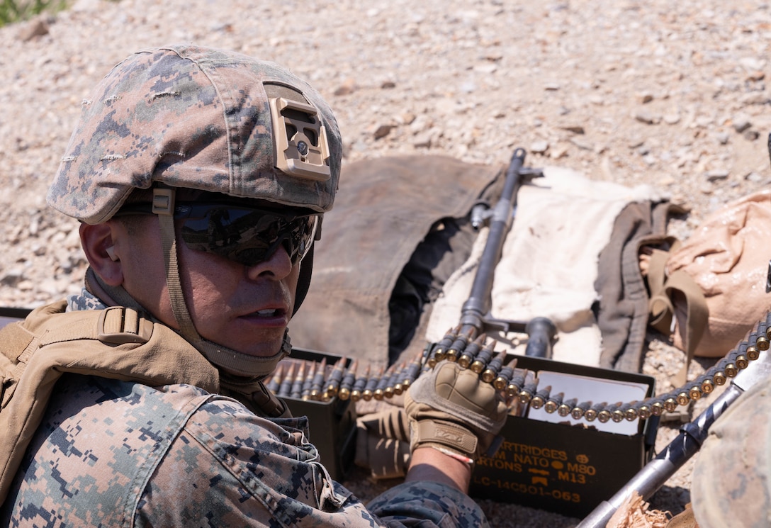 U.S. Marine Corps Sgt. Oscar Ochoa, a machine gunner with 2nd Battalion, 23rd Marines, forward deployed with 4th Marine Regiment, 3rd Marine Division as part of the Unit Deployment Program, feeds the ammunition belt into an M240B machine gun during the Korean Marine Exercise Program 25.2 in Suseong-ri, South Korea, July 30, 2025. KMEP is conducted regularly between the ROK and U.S. Marine Corps to increase their combined capabilities through realistic training geared towards deterrence and maintaining peace in the Indo-Pacific. Ochoa is a native of California. (U.S. Marine Corps photo by Cpl. Kanoa Thomas)