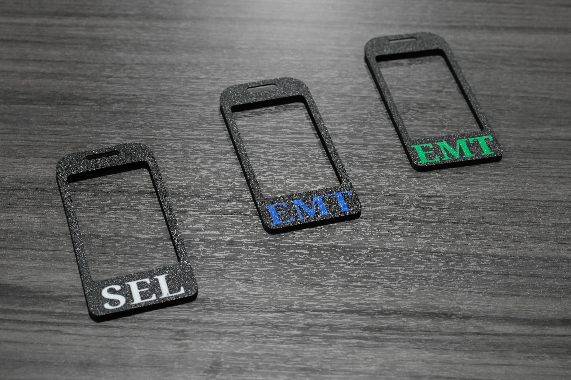 Badge holders sit on a table.