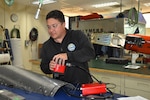 FRCSW engineer Dr. Justin Massey demonstrates composite damage assessment using advanced inspection technology. Massey, whose innovations in composite repair have saved the Navy millions, is departing FRCSW for a new role with the Office of Naval Research in Japan.