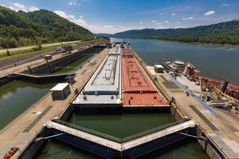 A barge locks through a river lock.