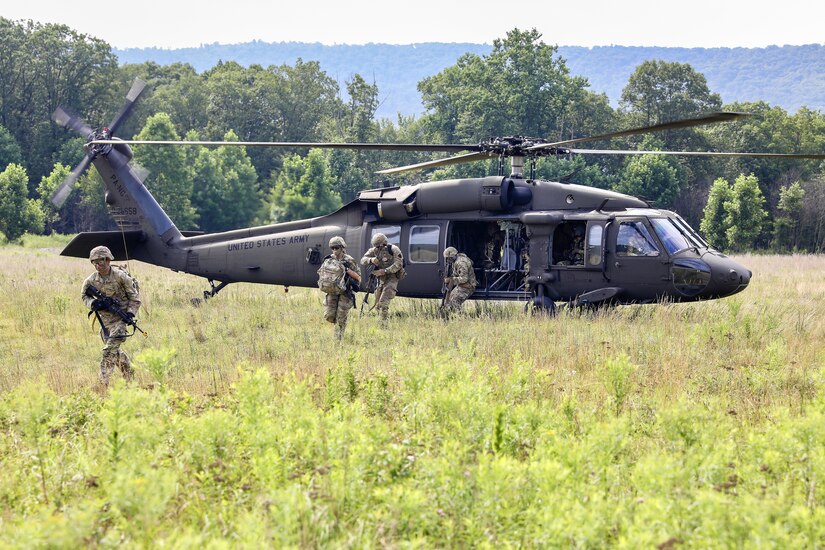 U.S. Soldiers with Charlie Company, 1st Battalion, 109th Infantry Regiment exit a UH-60 Black Hawk helicopter during an exercise at Fort Indiantown Gap, Pennsylvania, July 29, 2025. The Soldiers trained in an intensive 96 hour force-on-force exercise to simulate combat against a capable adversary. (U.S. Army National Guard photo by Staff Sgt. Zachery Jockel)
