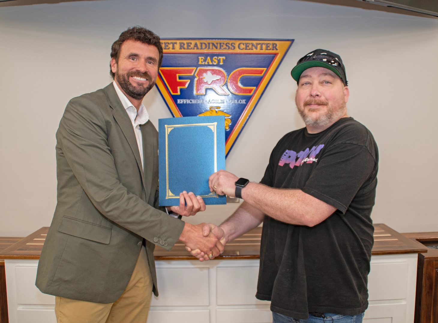 James Tutor, right, of Fleet Readiness Center East's Maintenance, Repair and Overhaul Logistics Department, earned recognition for his Beneficial Suggestion with an award presented by Department Head Jody Carey.