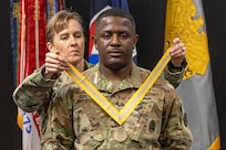 Brig. Gen. Paige M. Jennings, U.S. Army Financial Management Command commanding general, presents Sgt. 1st Class Deterrance Brown, USAFMCOM senior FM systems instructor, with a with a Maj. Gen. Nathan Towson Regimental Medallion at the Maj. Gen. Emmett J. Bean Federal Center in Indianapolis Jan. 31, 2024. The Towson was established by the U.S. Army Finance Corps Association on May 7, 1993, to recognize exceptional achievement or exemplary service by currently serving U.S. Army finance and comptroller commissioned officers, non-commissioned officers, enlisted Soldiers and civilians demonstrating exceptional leadership and whose accomplishments clearly distinguish them from their peers. (U.S. Army photo by Mark R. W. Orders-Woempner)