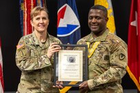Brig. Gen. Paige M. Jennings, U.S. Army Financial Management Command commanding general, presents Sgt. 1st Class Deterrance Brown, USAFMCOM senior FM systems instructor, with a with a Maj. Gen. Nathan Towson Regimental Medallion at the Maj. Gen. Emmett J. Bean Federal Center in Indianapolis Jan. 31, 2024. The Towson was established by the U.S. Army Finance Corps Association on May 7, 1993, to recognize exceptional achievement or exemplary service by currently serving U.S. Army finance and comptroller commissioned officers, non-commissioned officers, enlisted Soldiers and civilians demonstrating exceptional leadership and whose accomplishments clearly distinguish them from their peers. (U.S. Army photo by Mark R. W. Orders-Woempner)
