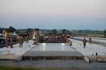 Airmen from the 157th Civil Engineer Squadron Prime Base Engineer Emergency Force and the 219th Civil Engineer Squadron pour 250 cubic yards of concrete at the 201st Regional Training Site, Fort Indiantown Gap, Pennsylvania, July 30, 2025. The large-scale concrete pour showcased joint efforts between New Hampshire and Montana Air National Guard engineers, reinforcing critical skills in airfield construction and multi-unit coordination.