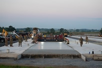Airmen from the 157th Civil Engineer Squadron Prime Base Engineer Emergency Force and the 219th Civil Engineer Squadron pour 250 cubic yards of concrete at the 201st Regional Training Site, Fort Indiantown Gap, Pennsylvania, July 30, 2025.