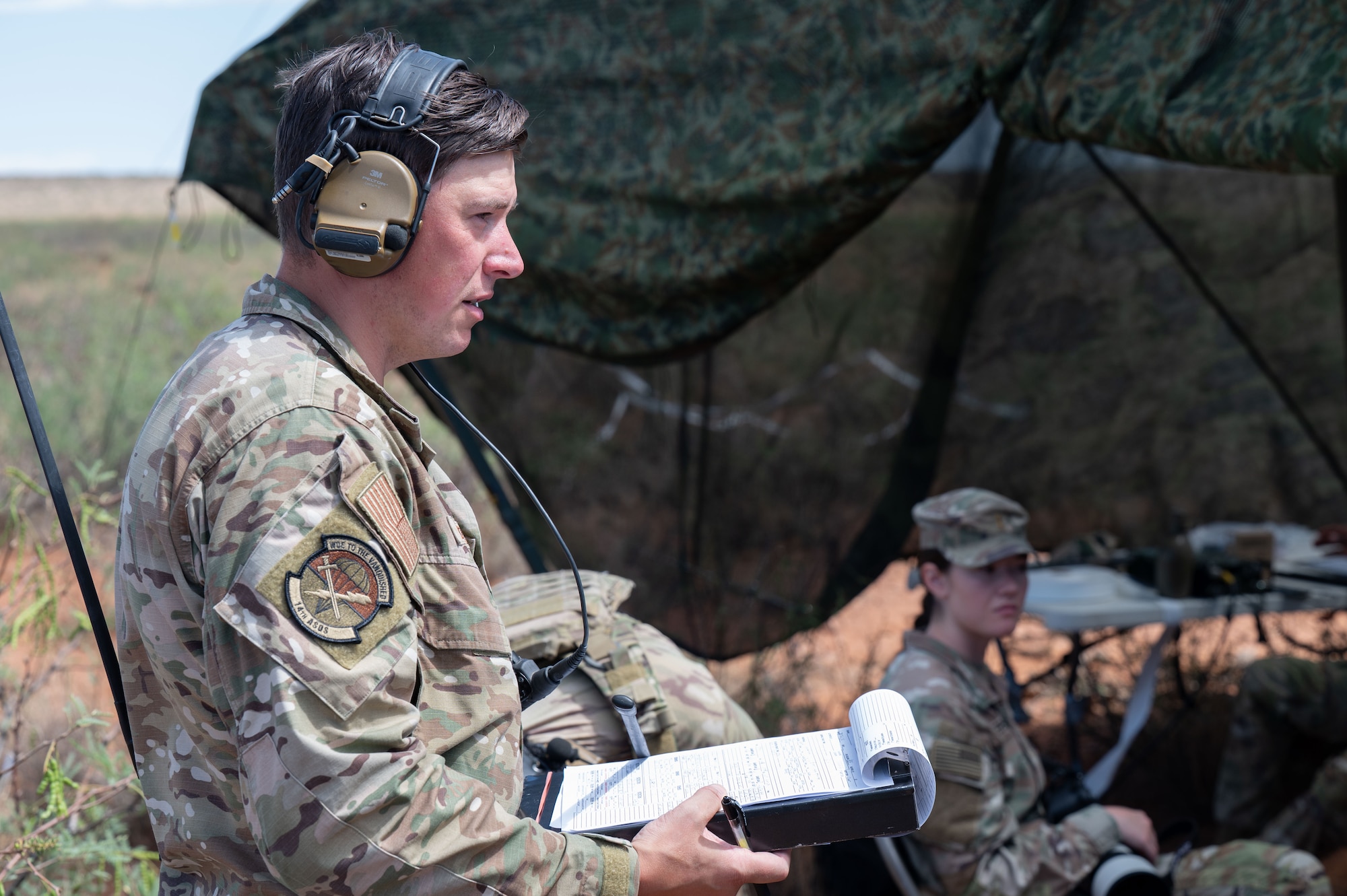 U.S. Air Force Master Sgt. Christopher Bechtold, 14th Air Support Operation Squadron flight chief, relays orders to a joint terminal attack controller during exercise Desert Dragon in Pearce, Arizona, July 31, 2025. Bechtold tested and evaluated JTACs’ ability to communicate between different parties during the exercise. (U.S. Air Force photo by Airman Jaden Kidd)